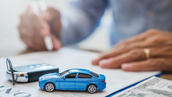 Car loan contract, car keys and toy car