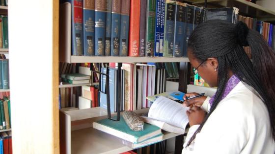 Scientist reading academic literature in the library