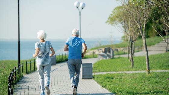 Back view portrait of active senior couple running